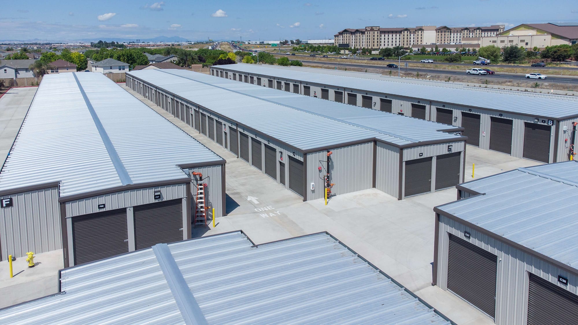 Aerial of Manteca Storage's unit rows with Highway 120 and the Great Wolf Lodge hotel behind it