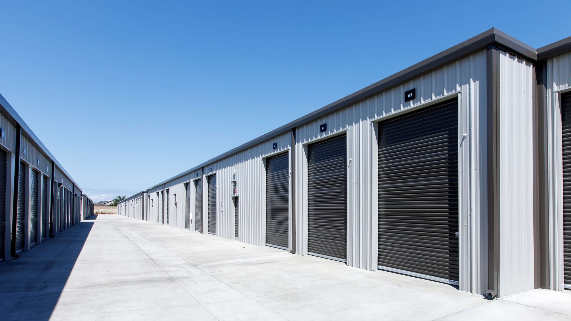 Tall roll-up doors on building A at Manteca Storage, sized for vehicles and full-household loads