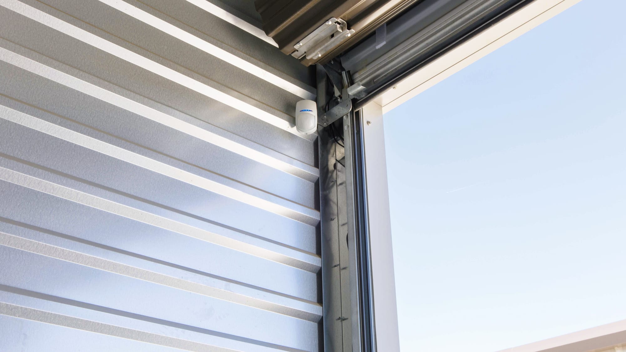A motion sensor mounted inside a Manteca Storage unit door, one per unit rather than only at the gate